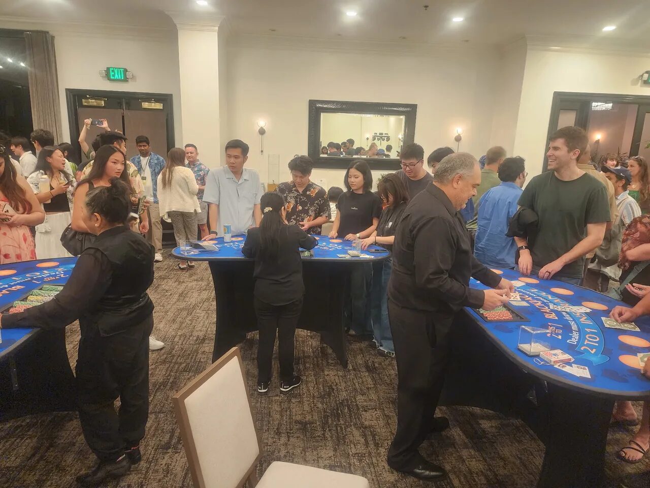 Birthday party crowd around a blackjack table at a Salt Lake City casino night