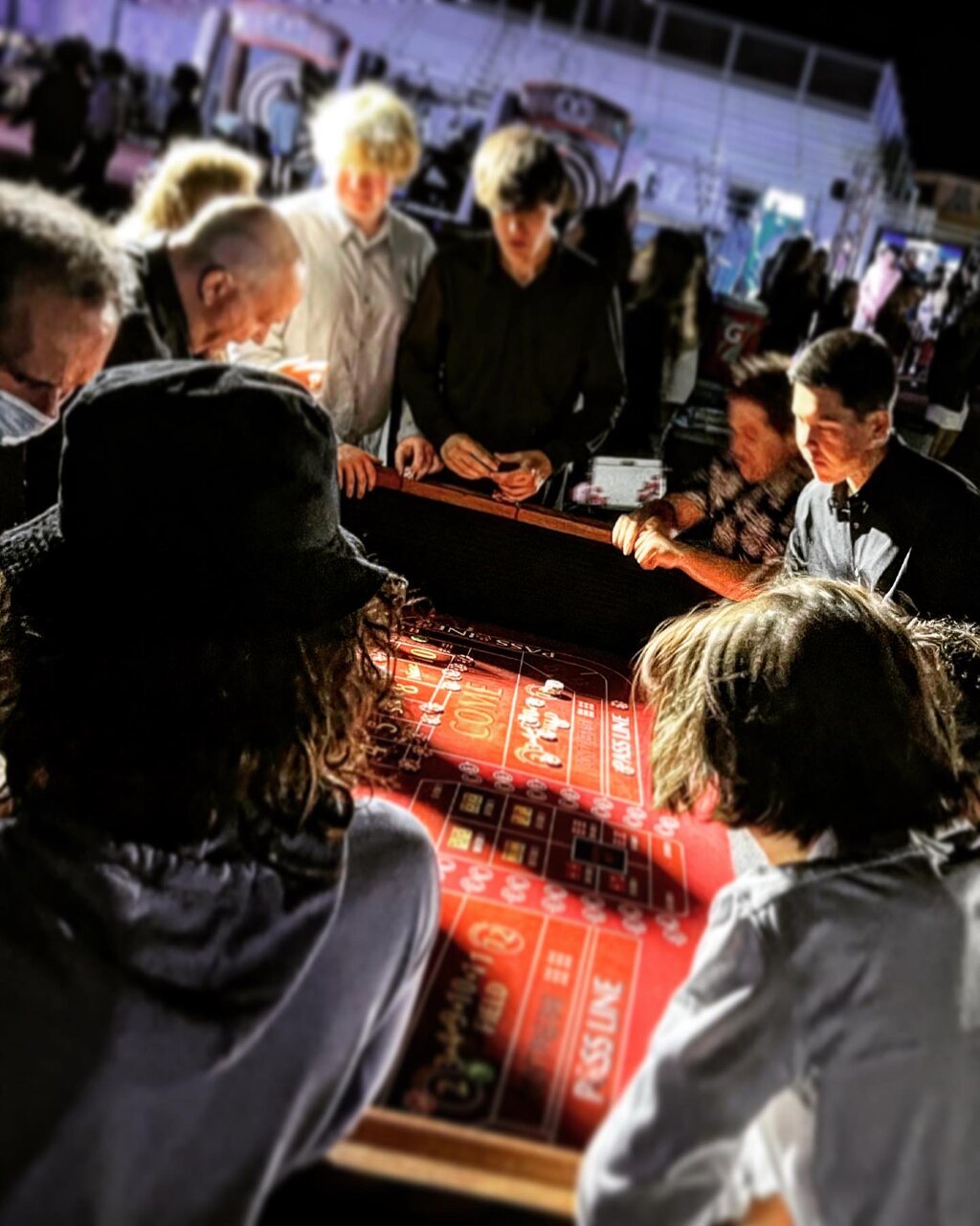 Packed casino party with guests crowding the gaming tables in Salt Lake City