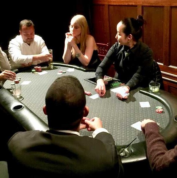 Players enjoying a poker table at an intimate Utah casino party