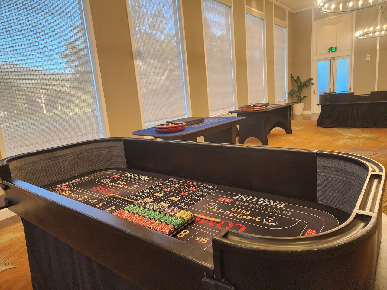 Craps table by floor-to-ceiling windows with a mountain view at a Park City venue